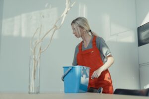 Professional house cleaner choosing best cleaning service supplies in San Jose home